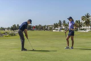 Couple playing golf at El Cid Golf & Country Club