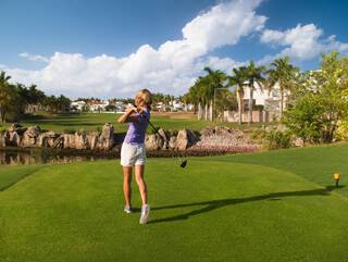 A woman playing golf at El Cid Golf & Country Club