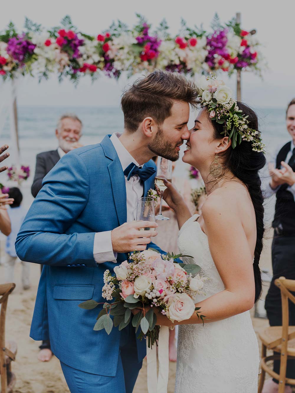 Bride and groom about to kiss with a flower alter in the background