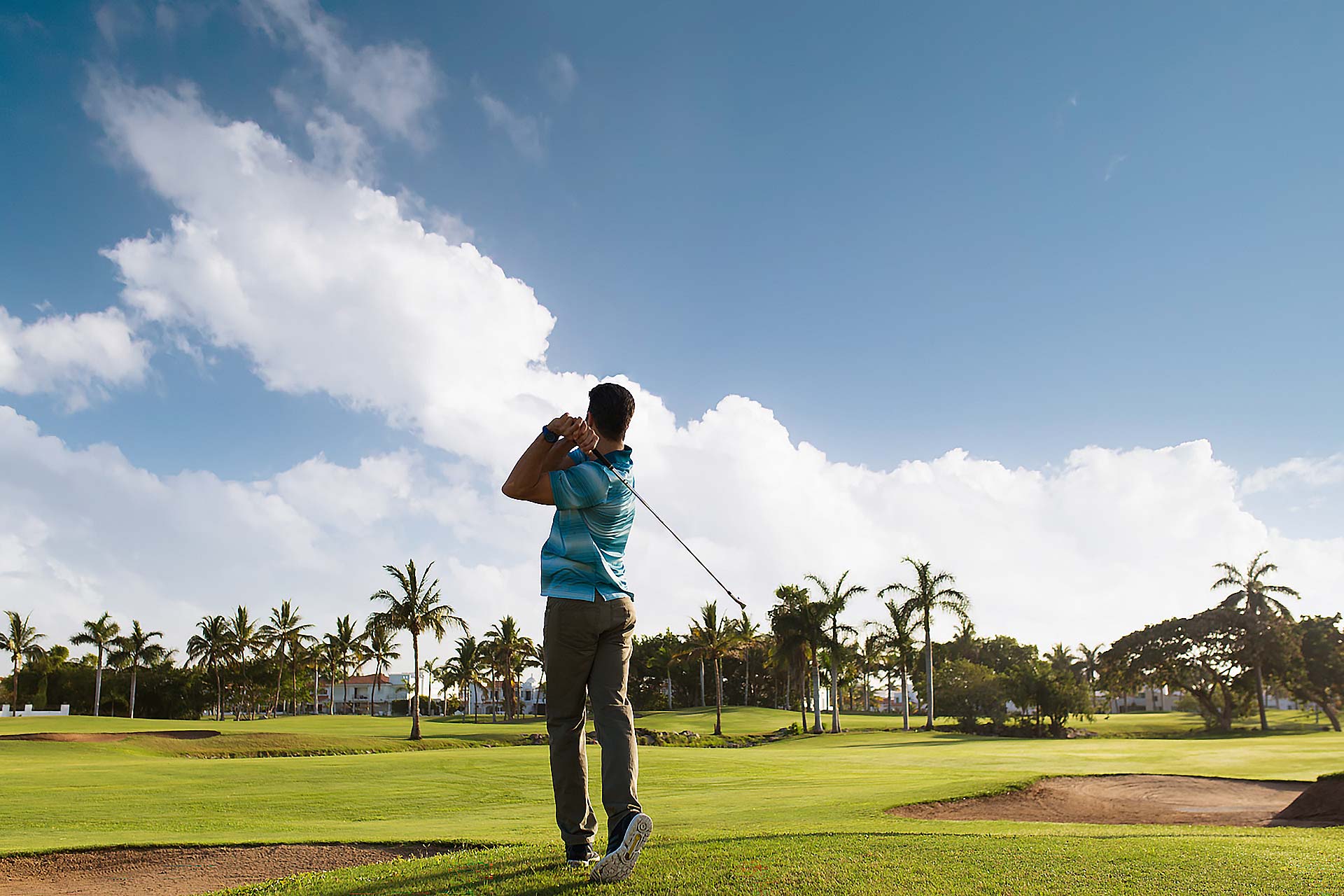 Rear view of a man playing golf